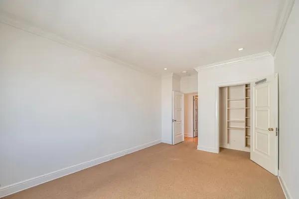 an empty room with closet area