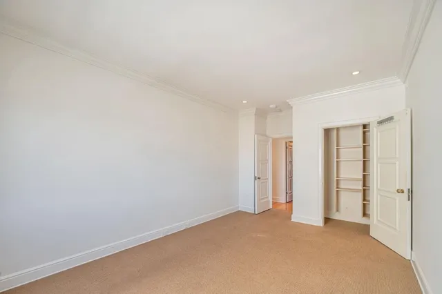 an empty room with closet area
