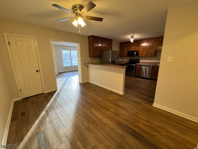 a view of kitchen with sink and refrigerator