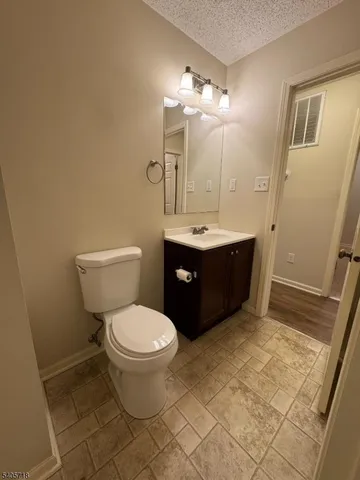 a spacious bathroom with a toilet sink and mirror