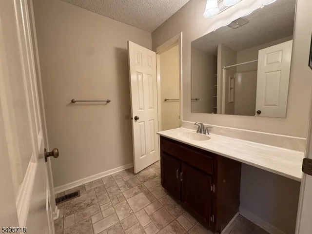 a bathroom with a double vanity sink a mirror and a