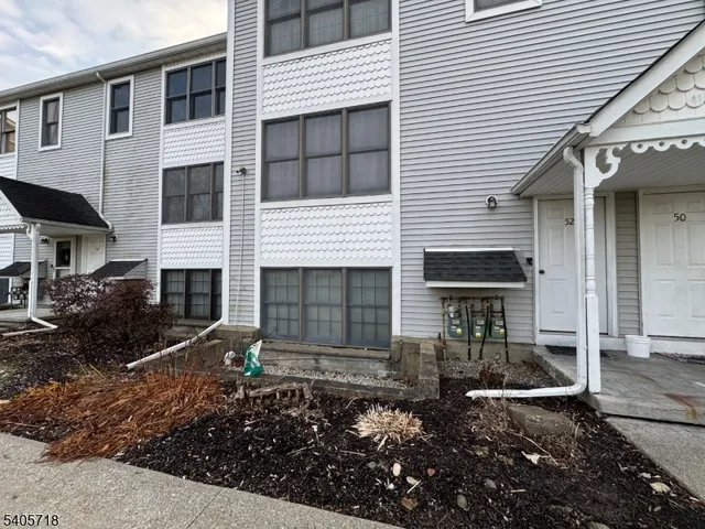 a view of a yard with wooden fence