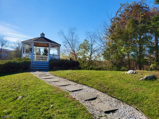 a swimming pool with an outdoor space and seating area