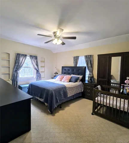 a spacious bedroom with a bed and a chandelier