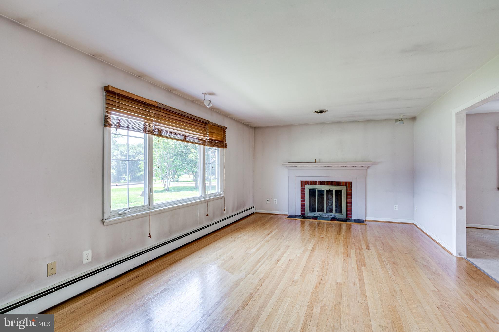 4595 Roundhill Road Ellicott City, MD 21043 - Photo 5 of 35 Living Room with wood-burning Fireplace