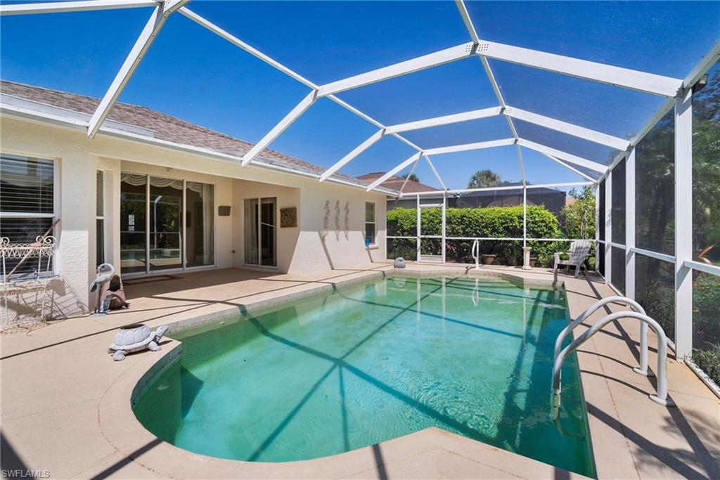 9281 Lanthorn Way Estero, FL 33928 - Photo 28 of 30 a view of a backyard with table and chairs and wooden fence