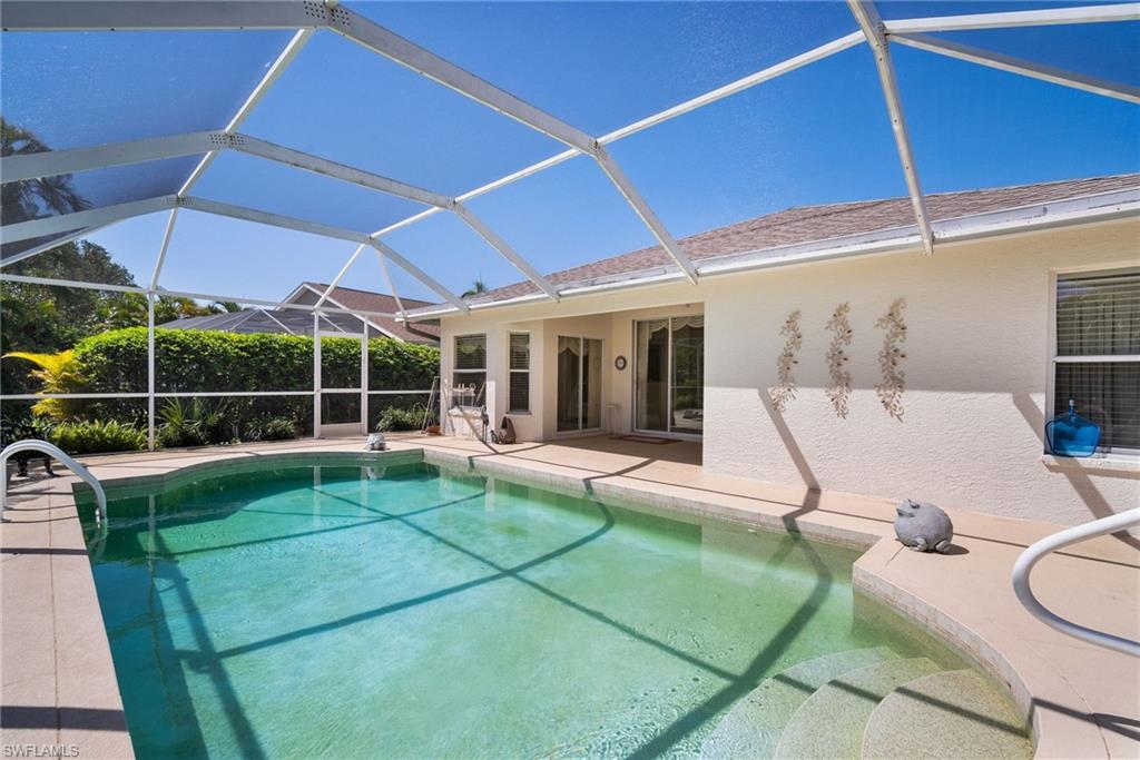 9281 Lanthorn Way Estero, FL 33928 - Photo 30 of 30 a view of a backyard with table and chairs under an umbrella