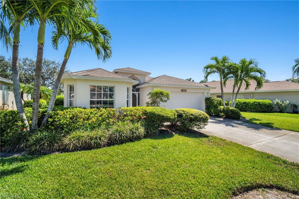 9281 Lanthorn Way Estero, FL 33928 - Photo 3 of 30 a front view of a house with a garden