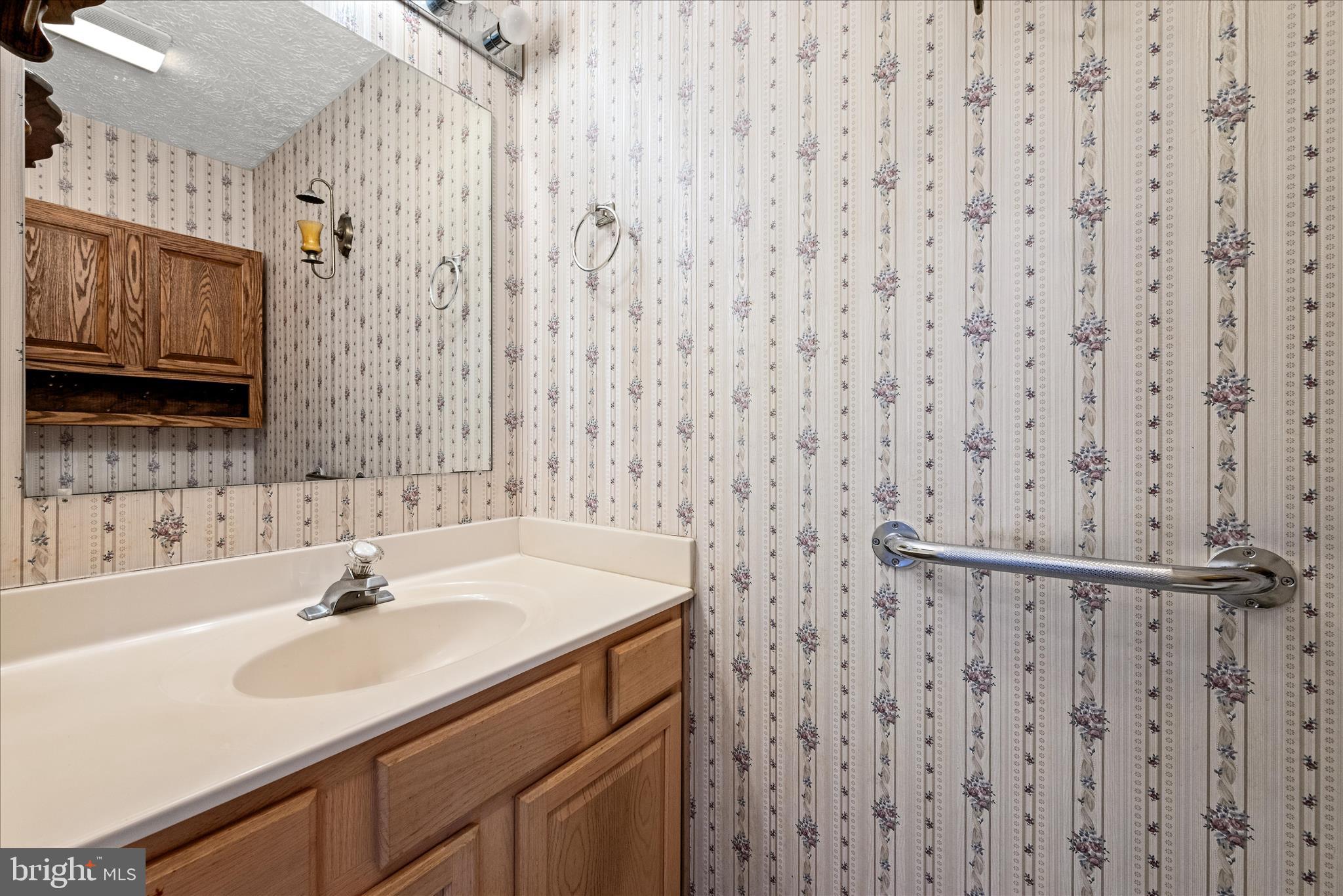 4403 Back Mountain Road Winchester, VA 22602 - Photo 20 of 73 a bathroom with a sink a mirror and a shower curtain
