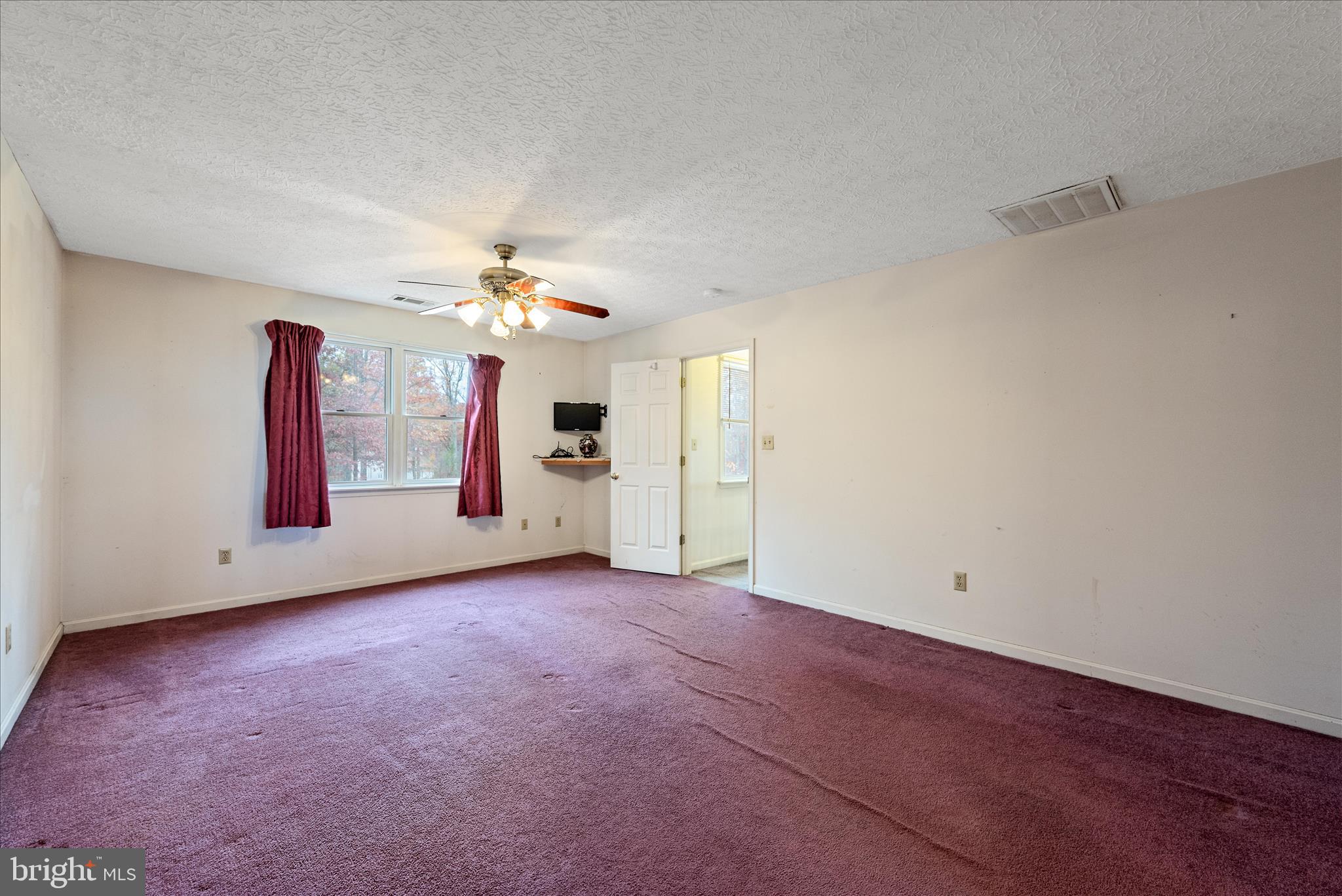 4403 Back Mountain Road Winchester, VA 22602 - Photo 32 of 73 an empty room with chandelier fan and windows