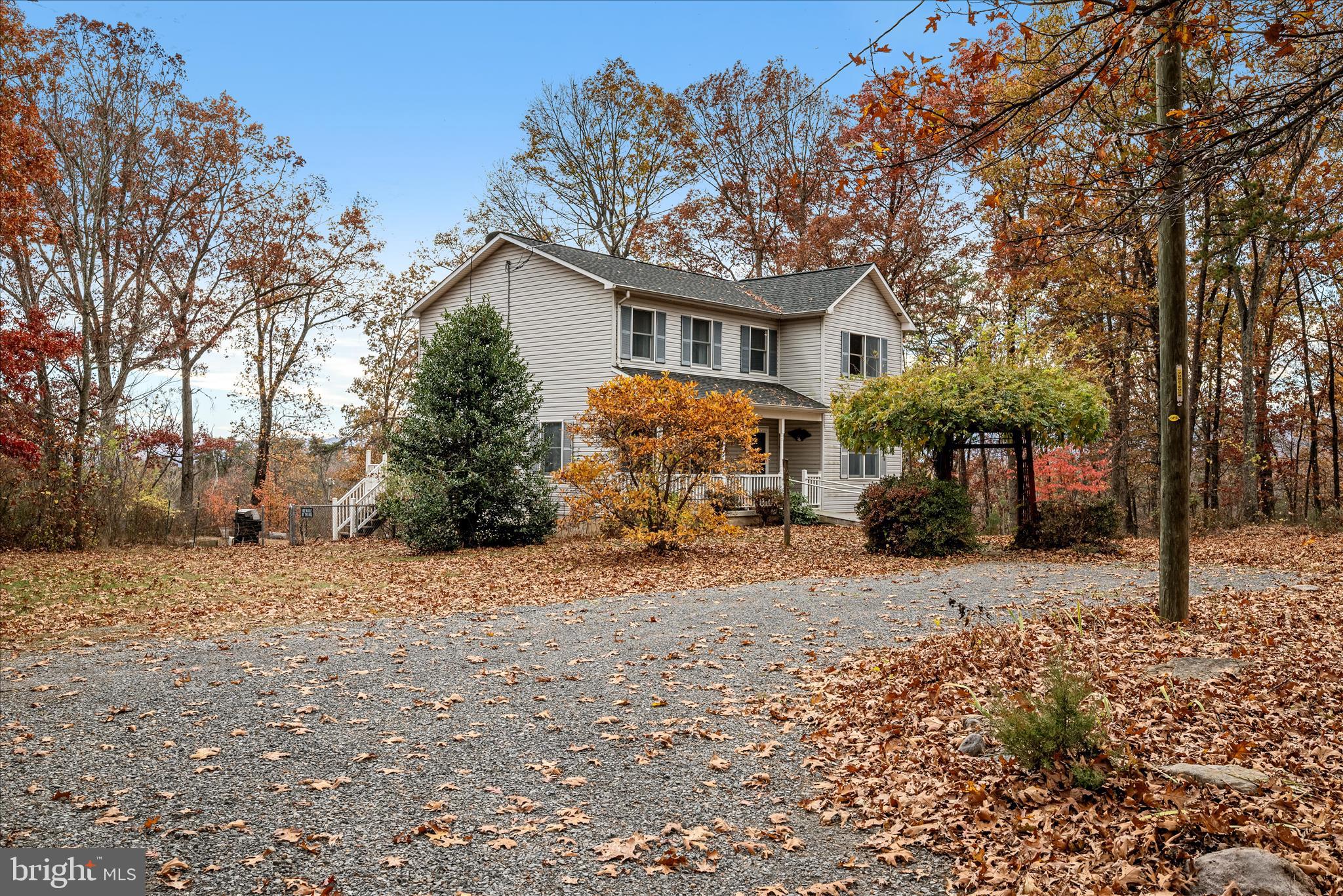 4403 Back Mountain Road Winchester, VA 22602 - Photo 69 of 73 a front view of a house with a yard covered with snow and trees