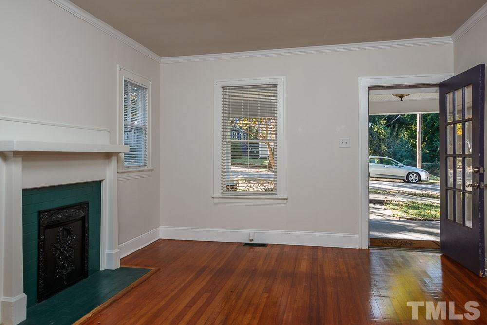 1306 Filmore Street Raleigh, NC 27605 - Photo 7 of 25 a view of an empty room with wooden floor and a window