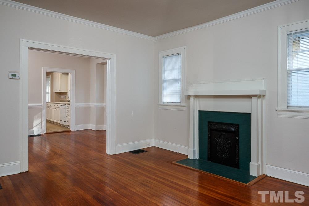 1306 Filmore Street Raleigh, NC 27605 - Photo 8 of 25 a view of a livingroom with wooden floor and a fireplace