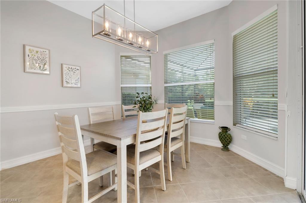 6757 Bent Grass Drive Naples, FL 34113 - Photo 11 of 27 a view of a dining room with furniture window and outside view