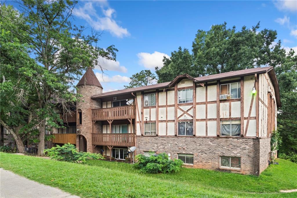 a front view of a house with a garden and plants
