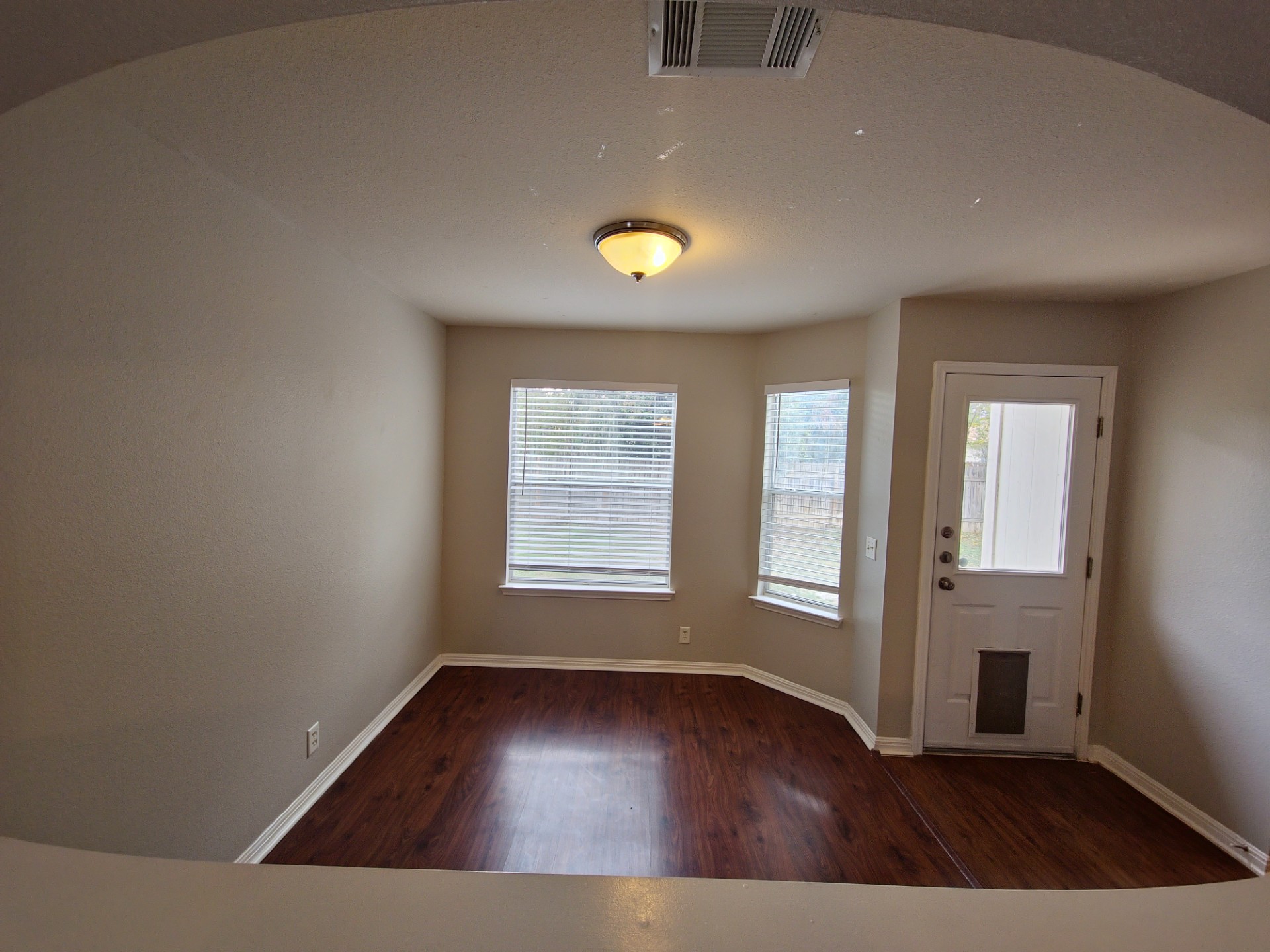 107 Orange Tree Lane Georgetown, TX 78626 - Photo 4 of 16 Hardwood style floors and bright windows illuminate this cozy dining space.