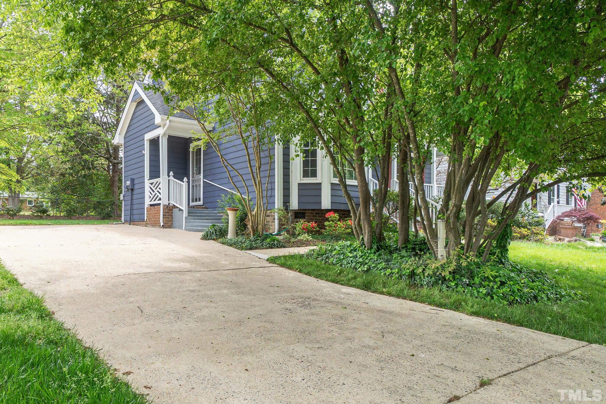 3525 East Jameson Road Raleigh, NC 27604 - Photo 2 of 15 a front view of a house with a garden and trees