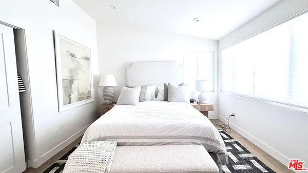 a bedroom with a large bed and a window