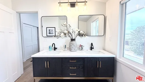 a bathroom with a sink vanity and a mirror