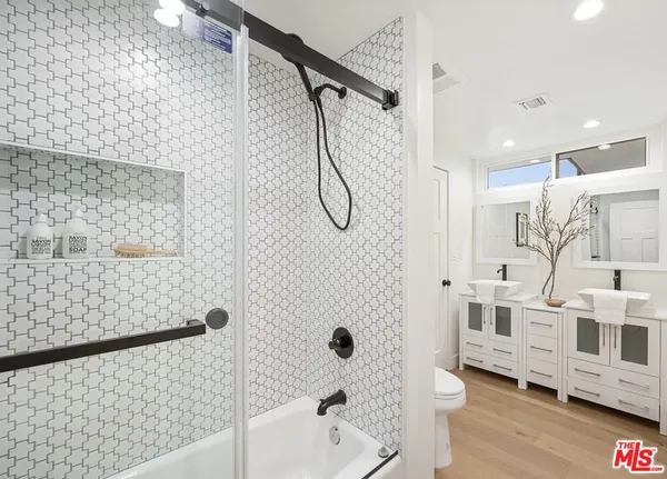 a white toilet sitting next to a bathroom sink