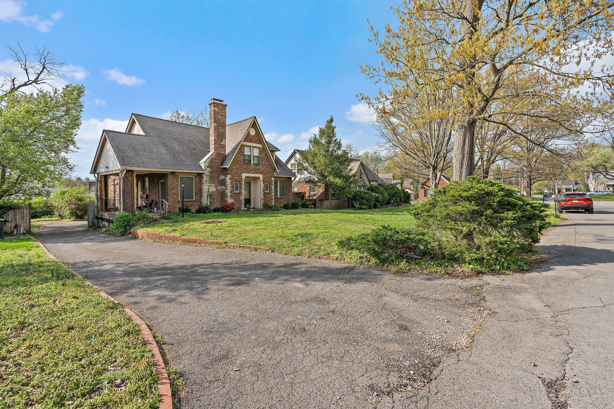 225 Mockingbird Road Nashville, TN 37205 - Photo 4 of 35 a view of a big house with a big yard and large trees