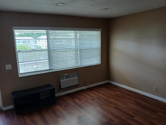 a room with a window and wooden floor