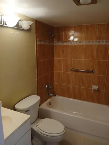 a bathroom with a toilet and a bath tub