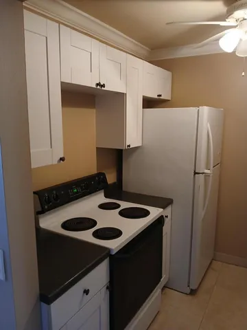 a kitchen with a refrigerator and a stove