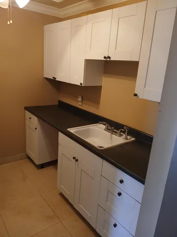 a kitchen with a sink and cabinets