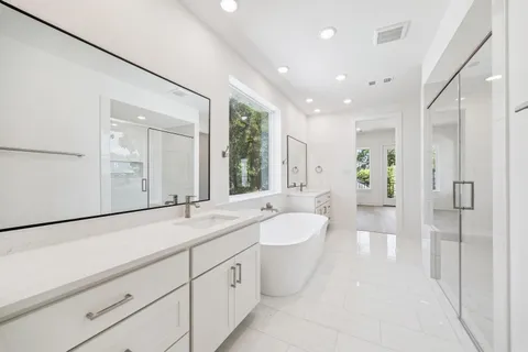 a spacious bathroom with a granite countertop sink and a mirror