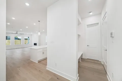 a view of a hallway with wooden floor