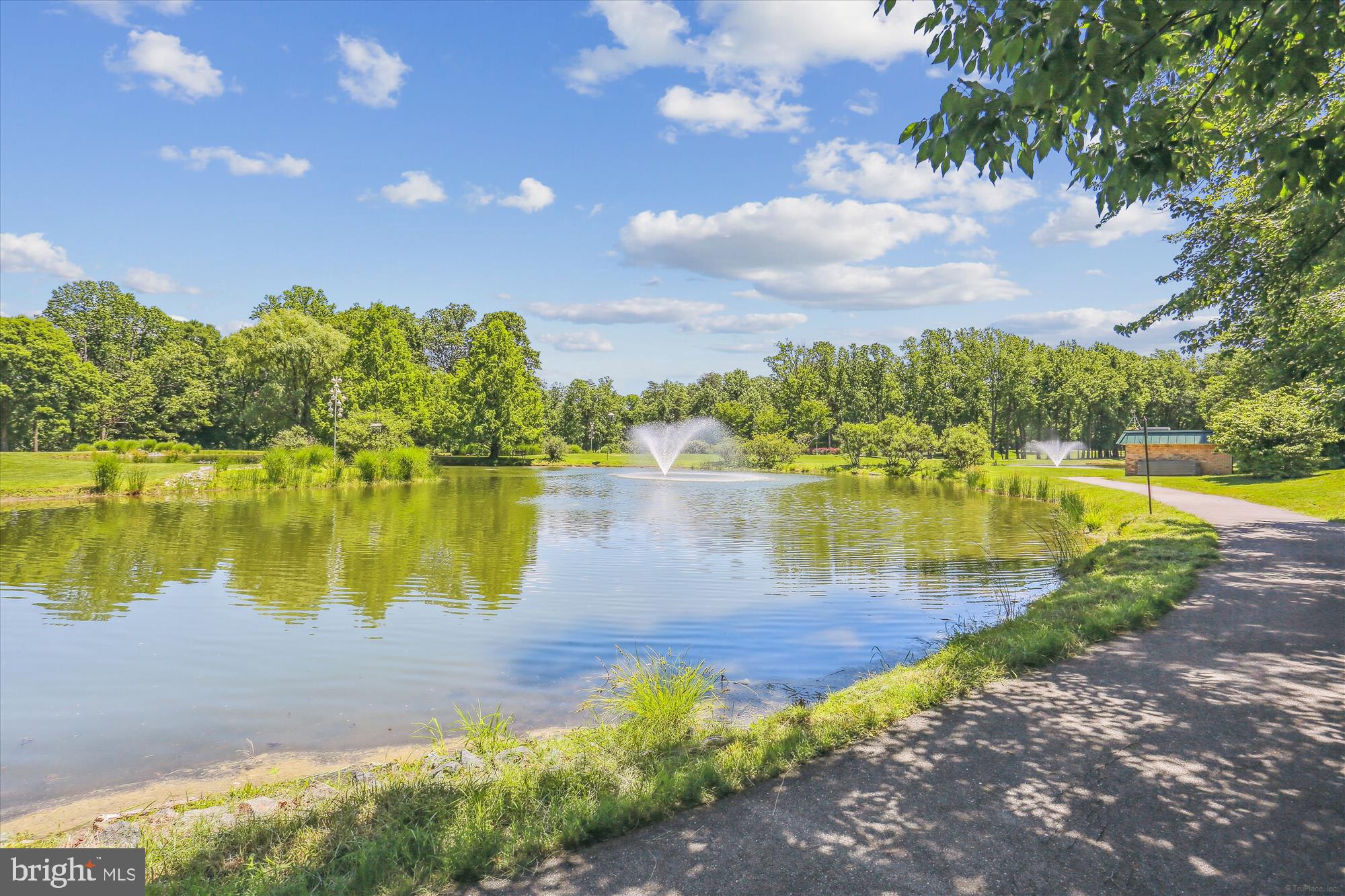 15115 Interlachen Drive, Unit 3308 Silver Spring, MD 20906 - Photo 20 of 50 a view of a lake with a yard