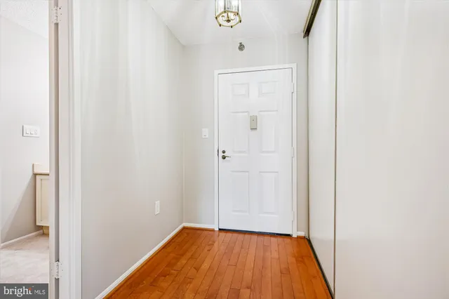 a view of a hallway with wooden floor