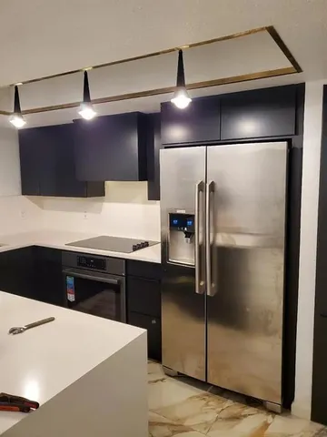 a kitchen with a refrigerator and a sink