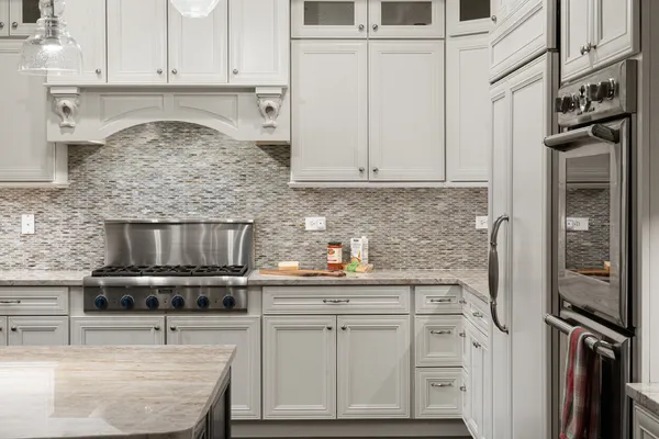a kitchen with stainless steel appliances kitchen island granite countertop a stove a sink and a refrigerator
