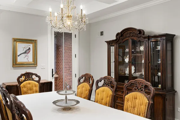 a view of a dining room with furniture and chandelier