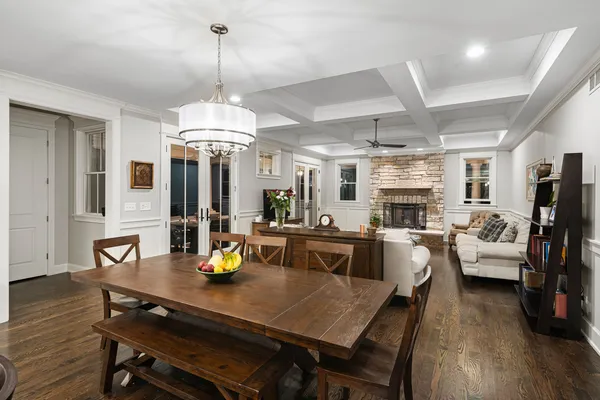 a kitchen area with stainless steel appliances dining table and chairs