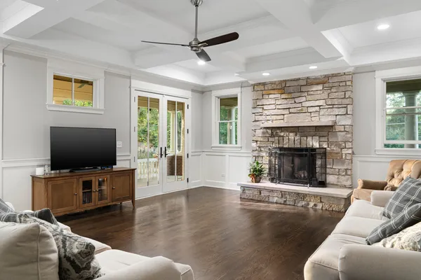a living room with furniture a flat screen tv and a fireplace