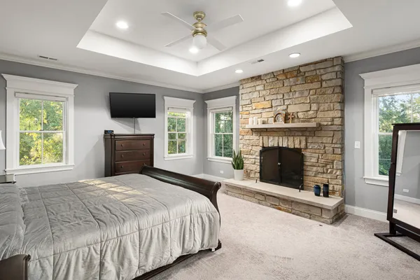 a spacious bedroom with a bed and a fireplace