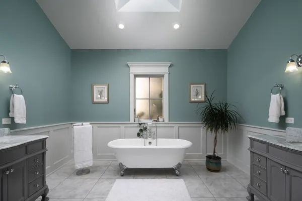a spacious bathroom with a double vanity sink and a bathtub