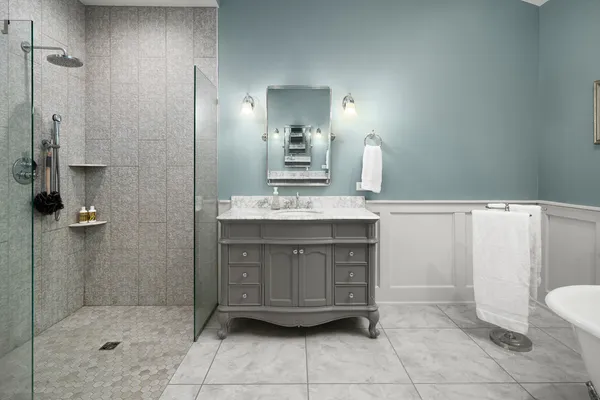 a bathroom with a sink a toilet and shower