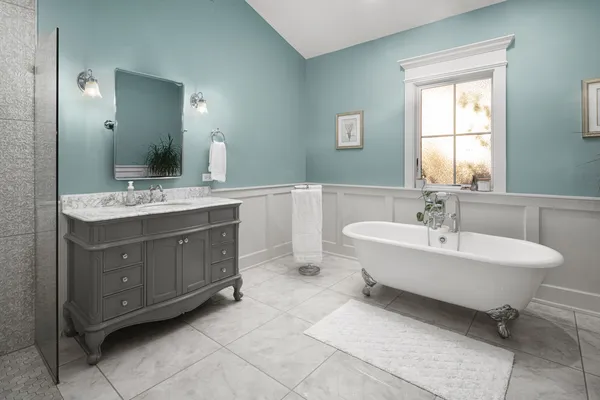 a spacious bathroom with a double vanity sink mirror and bathtub