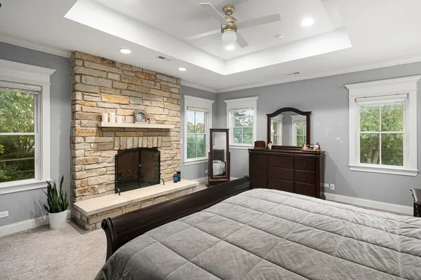a bedroom with a bed and a fireplace