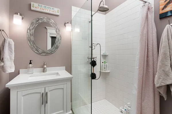 a bathroom with a sink a toilet and a mirror