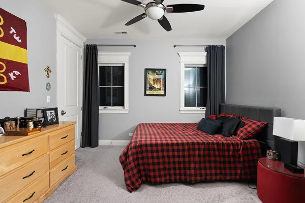 a bedroom with a bed and ceiling fan