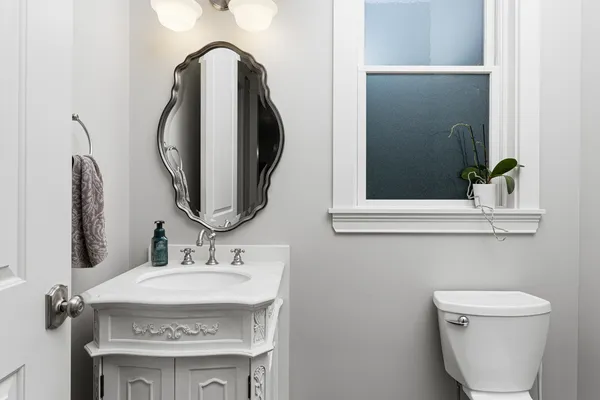 a bathroom with a toilet sink and mirror