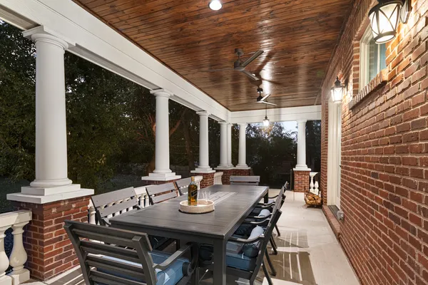 a backyard of a house with table and chairs