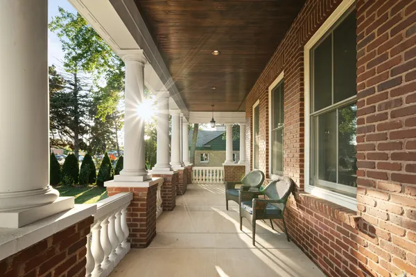 a building outdoor space with patio furniture and potted plants