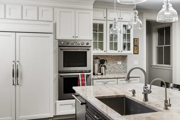 a kitchen with a sink stove and cabinets