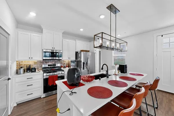 a kitchen that has a table chairs and a stove
